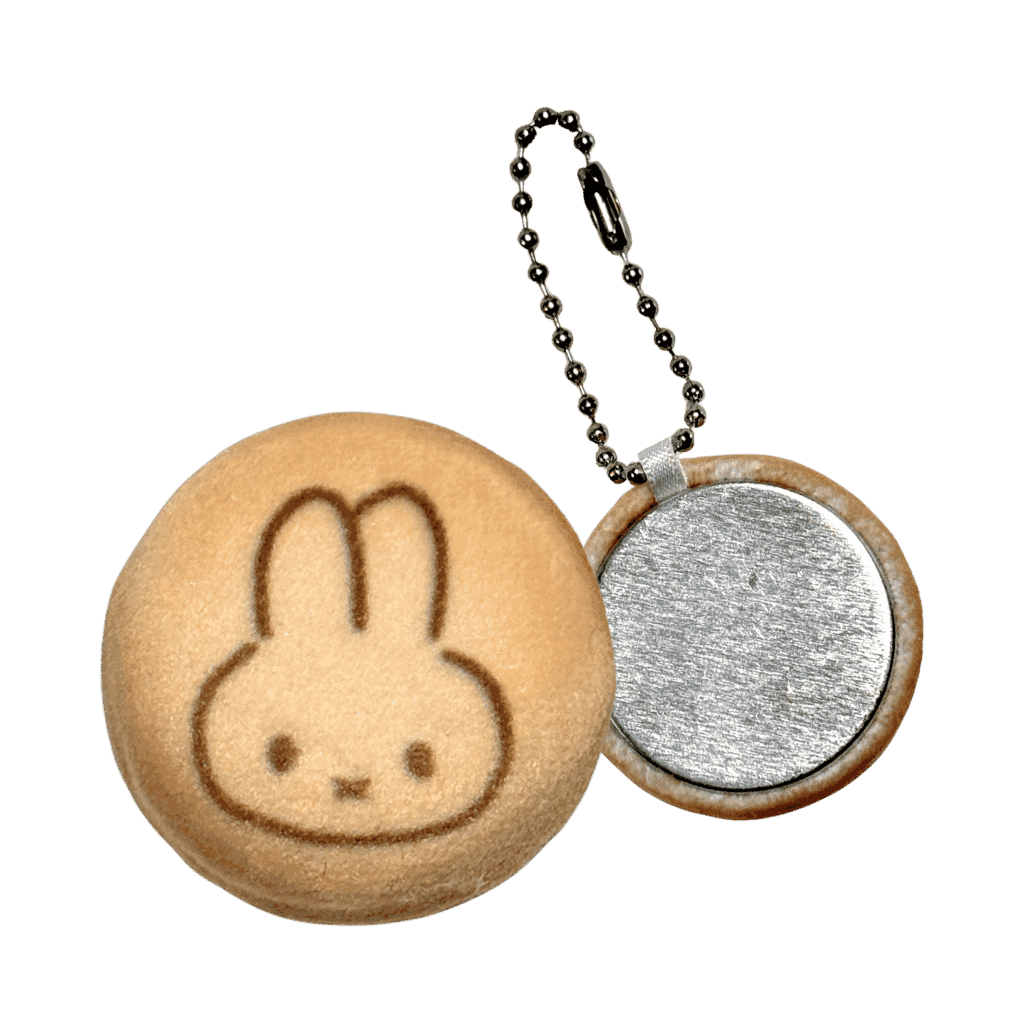 Round keychain with a cartoon face design