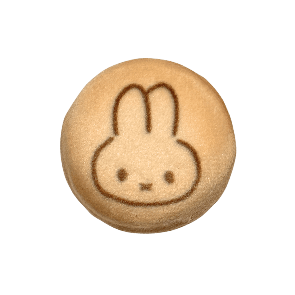 Round cookie with a rabbit face design on a transparent background